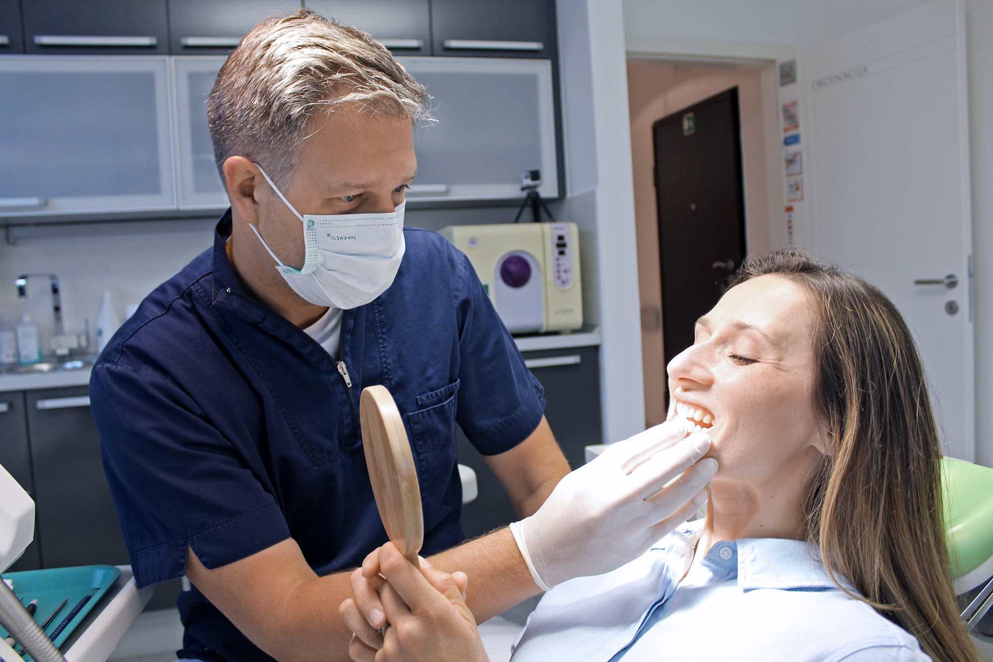 Dr. Danny Goljak treating patient with a friendly smile