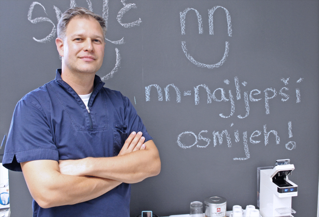 Dr. Danny Goljak treating patient with a friendly smile